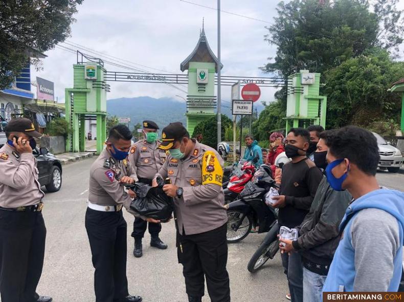 Kapolres Solok Arosuka AKBP Azhar Nugroho S, IK. M,Si saat membagikan nasi bungkus di pangkalan ojek.