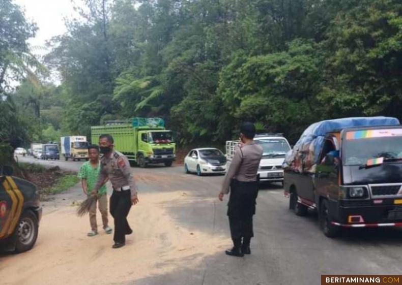 Polisi yang sedang membersihkan tumpahan minyak sawit.