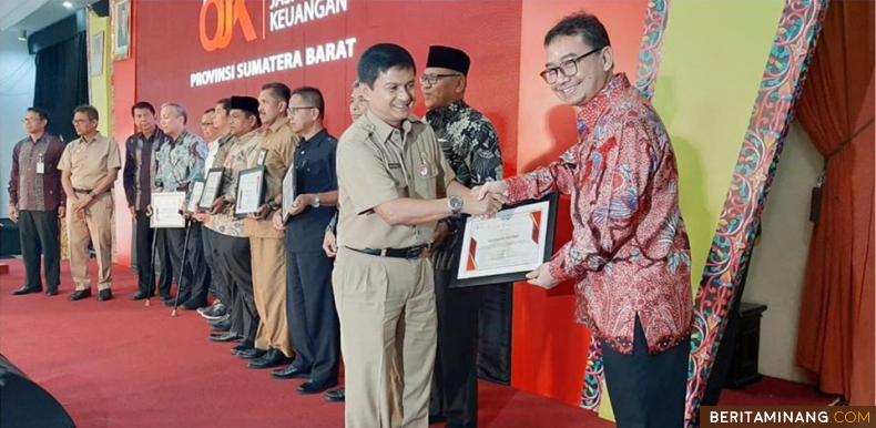 Penghargaan dari Otoritas Jasa Keuangan (OJK) Pusat kepada Wali Kota Padang yang diwakili Asisten Administrasi Didi Aryadi di Auditorium Gubernuran Sumbar, Selasa (17/12/2019)